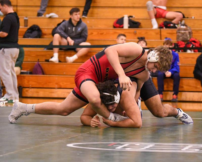 Joseph Favia of Marmion Academy, right, keeps a hold of Batavia’s wrestler Asher Sheldon where Joseph took the regional title win 215 wieght class on Saturday Feb. 3, 2024, held at Glenbard West High School.
