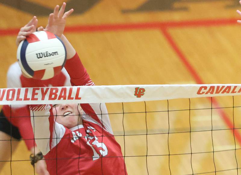 Mendota's Drew Depenbrock blocks a spike from Washington during the Class 3A Sectional final game on Thursday, Nov. 6, 2025 in Sellett Gymnasium at L-P High School.