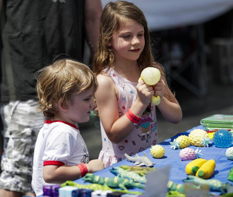 Parker, 4, and Kailani Gronko, 7, of Northlake look at a craft table during the Spring Fling in Westmont, Ill. on Sunday, May 29, 2022.