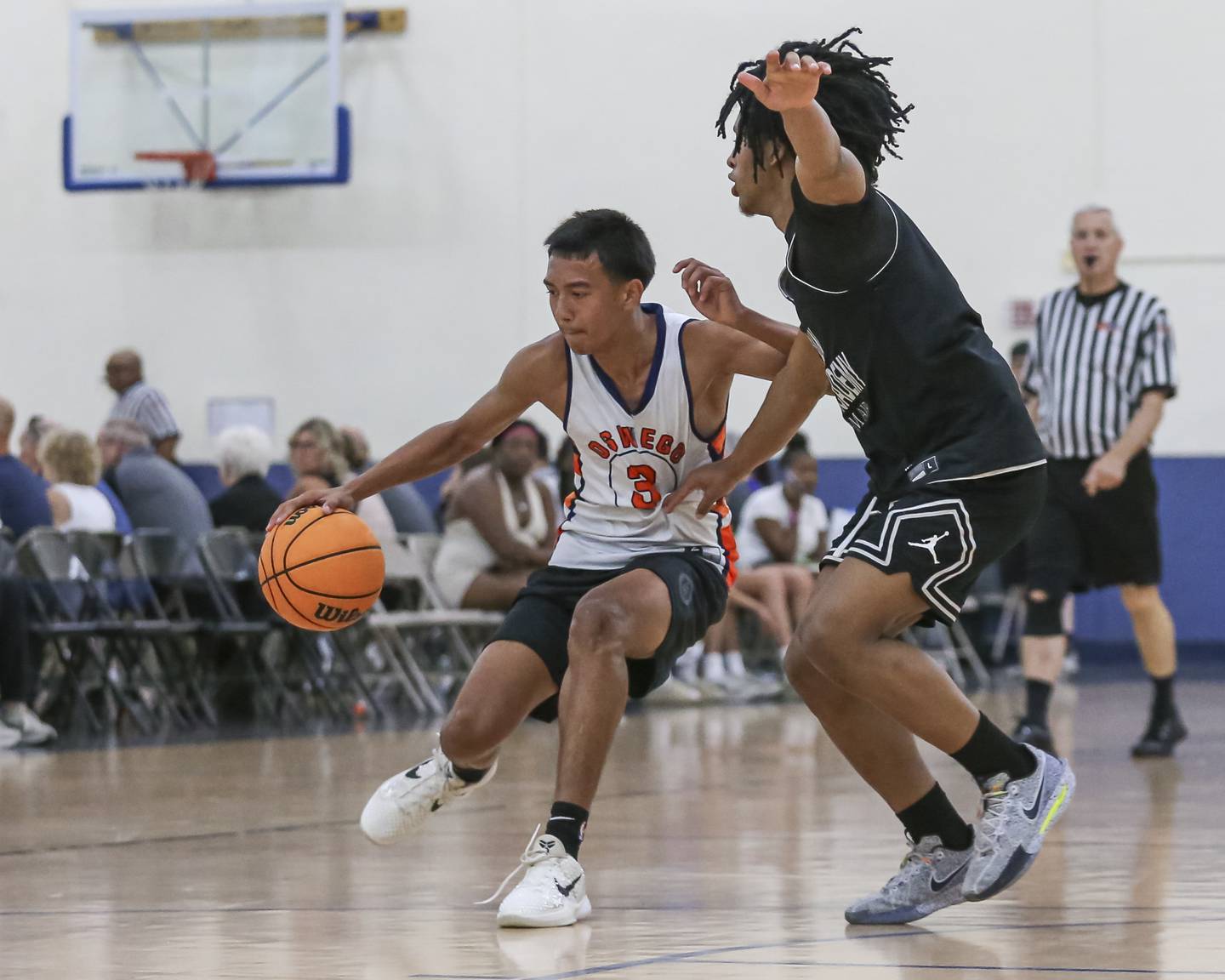Oswego's Ethan Vahl (3) handles the ball against the defense in their Riverside-Brookfield Shootout basketball game.  June 20, 2025 in Riverside.