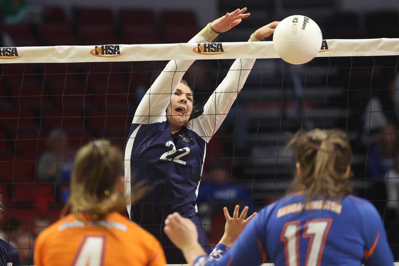 IC Catholic’s Jenny Fromelt knocks down a shot against Genoa-Kingston in the Class 2A championship match on Saturday in Normal.