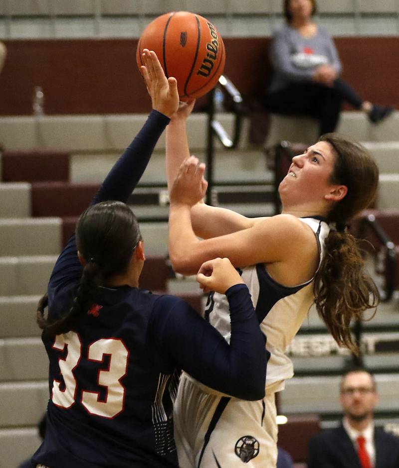 Cary-Grove's Kennedy Manning tries to shoot the ball over St. Viator's Mia Bergstrom during an IHSA Class 3A Antioch Sectional semifinal girls basketball game on Tuesday, Feb. 20, 2024, at Antioch High School.