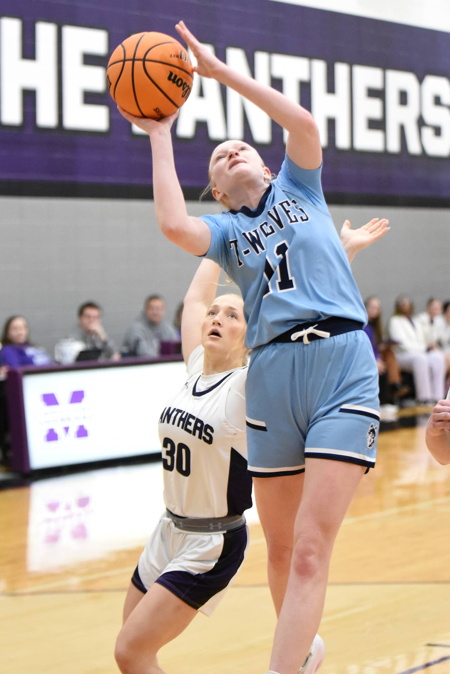 Cissna Park's Sophie Duis, right, puts back an offensive rebound in front of Manteno's Kendall Blanchette during a game at Manteno Monday, Jan. 19, 2026.