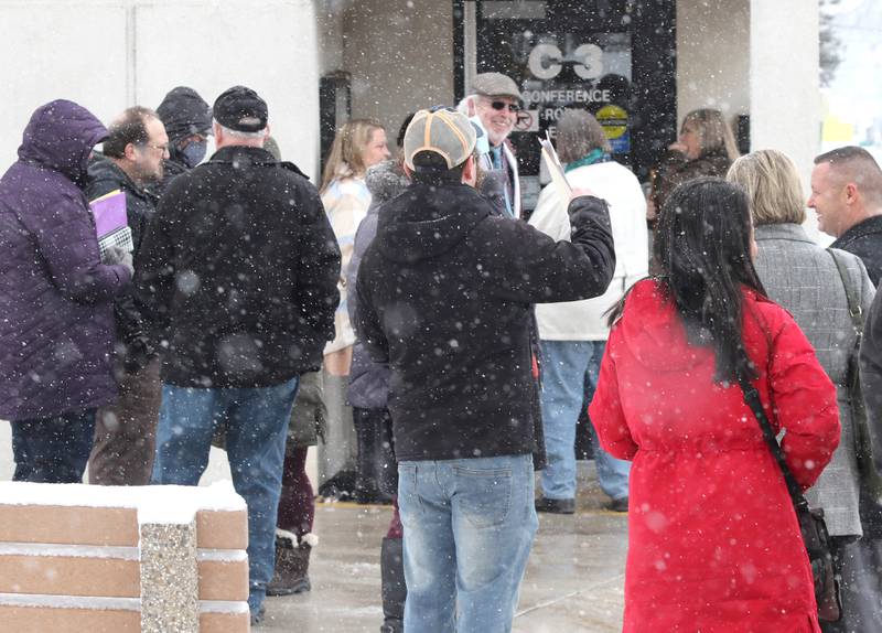 Candidates wait in line on a snowy Monday, March 7, 2022, at the DeKalb County Administration Building in Sycamore, to file their petitions to get their names on the ballot for the November 2022 midterm election. Monday was the first day candidates could file.