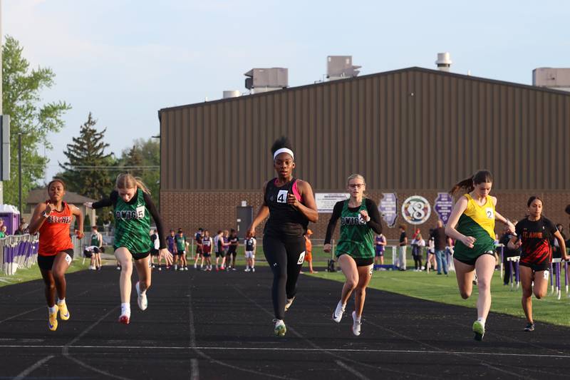 Kankakee's Jemya Williams, center, strides across the finish line during the 100-meter race at the Manteno Track Invite on Friday, April 24, 2026. Williams would take second overall behind teammate Mikiah Robicheaux.