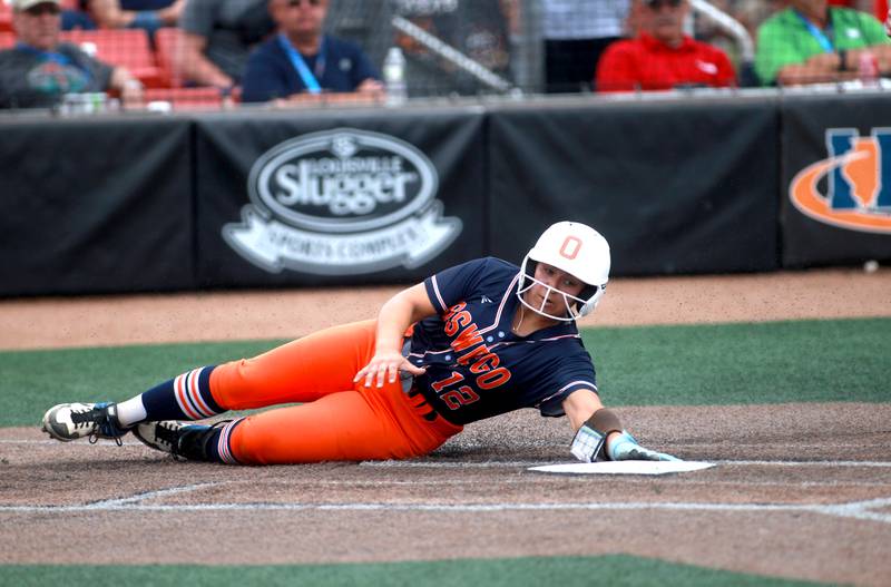 Oswego's Aubriella Garza slides safely into home plate during a IHSA Class 4A state semifinal game against Oak Park-River Forest on Friday, June 13, 2025 at the Louisville Slugger Sports Complex in Peoria.