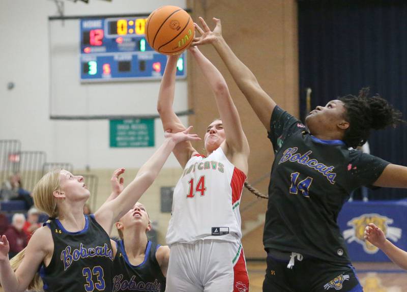 L-P's Drew Depenbrock plows through the lane to score a basket over Somonauk's Abby Hohmann and teammate Leah Norris during the Tim Humes Breakout Tournament on Friday, Nov. 22, 2024 at Somonauk High school.