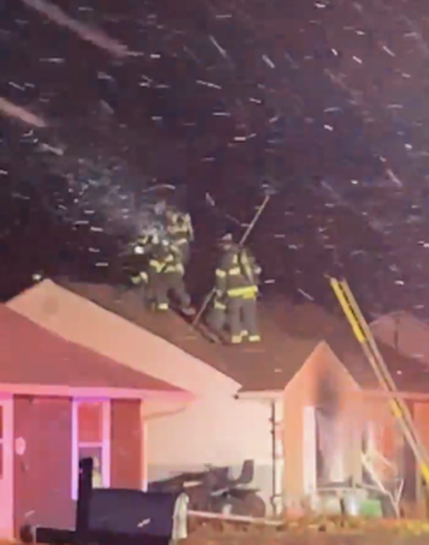Firefighters seen on the roof of a house on Burbank Street in Plainfield Township on Thursday. The fire was ignited by a candle, according the Plainfield Fire Protection District. Dec. 18, 2025