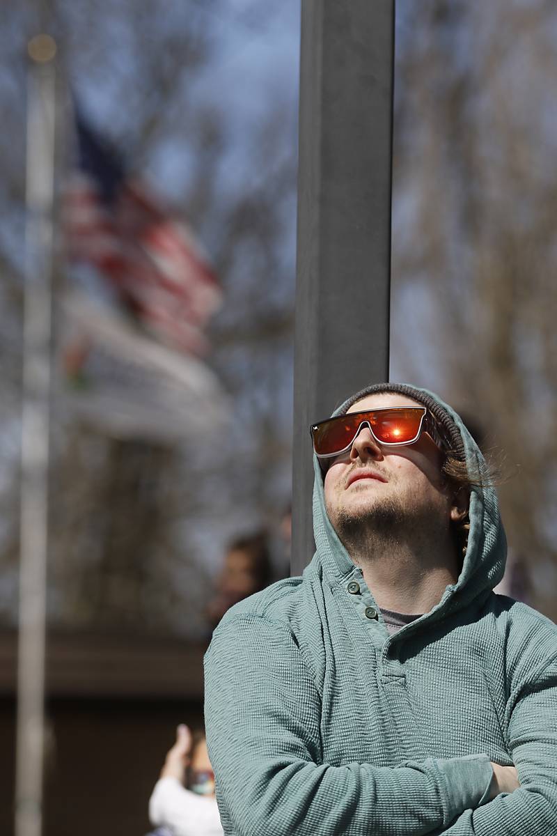 Cerry Armstrong of Cary watches the partial eclipse Monday, April 8, 2024, at the Crystal Lake Park District's Nature Center.