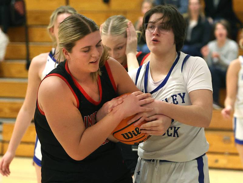 Indian Creek's Madison Boehne (left) and Hinckley-Big Rock's Grace Hall fight for the ball during their game Thursday, Jan. 29, 2026, at Hinckley-Big Rock High School.