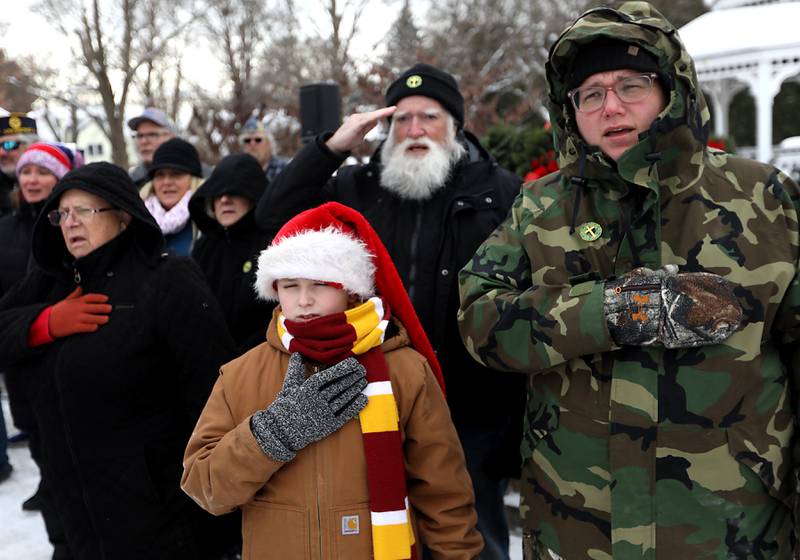 Bonnie Hazelwood (right) and her son, Michel during the “National Anthem” during McHenry's Wreath Laying Ceremony in honor of fallen veterans on Friday, Dec. 5, 2025, at St. Mary's Catholic Cemetery in McHenry. The event was hosted by McHenry American Legion Post 491 and Team Home Depot.