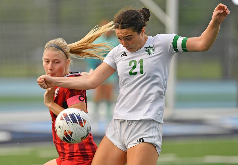 York’s Andriana Soupos (21) and Hinsdale Central’s Peyton Rohn go for the ball during the Class 3A Downers Grove South Sectional final game on May 30, 2025 at Downers Grove South High School in Downers Grove .