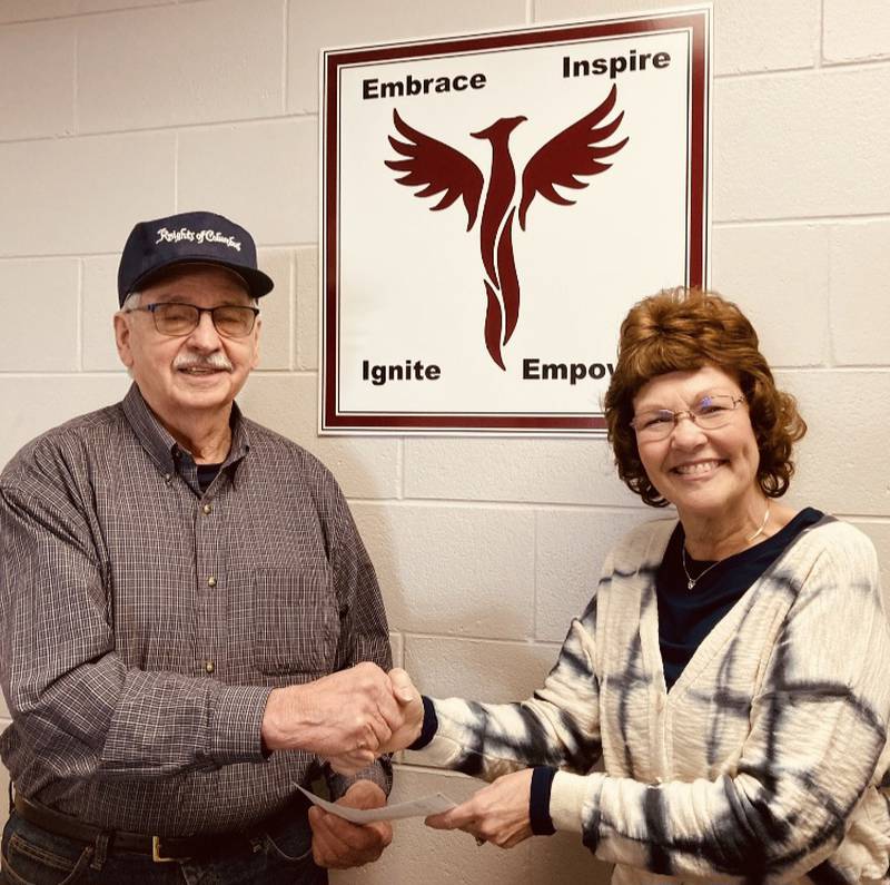 Knights of Columbus Tootsie Roll Chairman, Doug Ossola presents a donation to Executive Director of Lighted Way Jessica Kreiser.