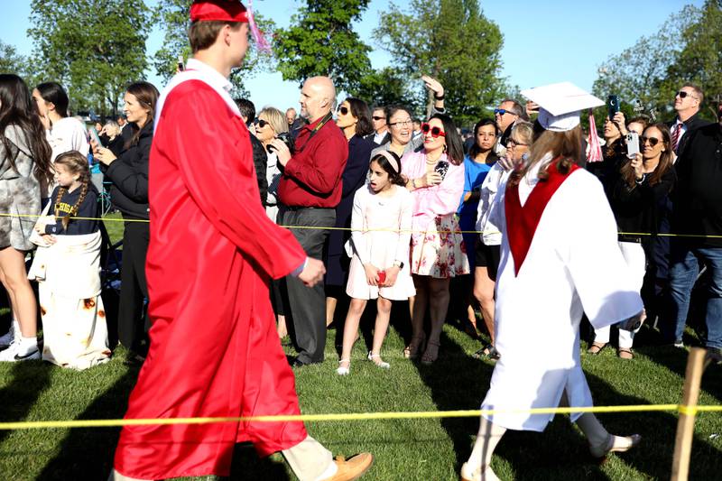 Parents and family members watch as Benet graduates process into Gilbert-Baumgartner Stadium for the school’s commencement ceremony in Lisle on Thursday, May 25, 2023.
