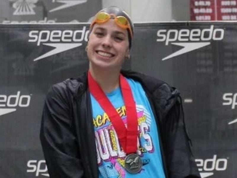 Mendota senior Bridget McGann stands on the podium after placing second in the 100-meter breaststroke at the National Club Swimming Association Summer Championships with a time of 1:09.81, which qualified her to compete in the 2024 USA Swimming Olympic Trials in June in Indianapolis.
