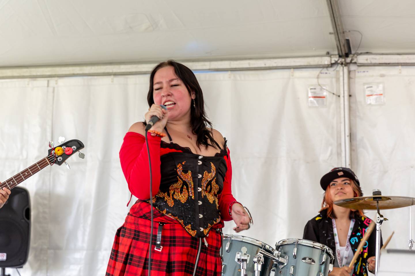 School of Rock student Mollee O'Heron belts out a song backed by her band at the Lockport Comicopolis July 20th, 2024.