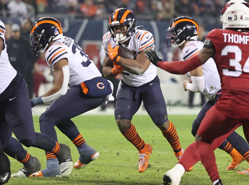 Chicago Bears running back Khalil Herbert finds a hole in the Arizona Cardinals line in the fourth quarter of their game Sunday, Dec. 24, 2023, at Soldier Field in Chicago.