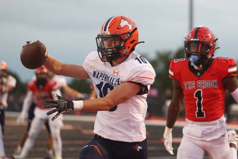 Naperville North’s Carson Marlar holds the ball out after a touchdown catch against Bolingbrook on Friday, Sept. 8, 2023 in Bolingbrook.