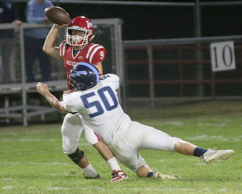 Hall's quarterback Gianni Guerrini is hit as he throws the ball by Bureau Valley's Connor Scott on Friday, Sept 8, 2023 at Richard Nesti Stadium.