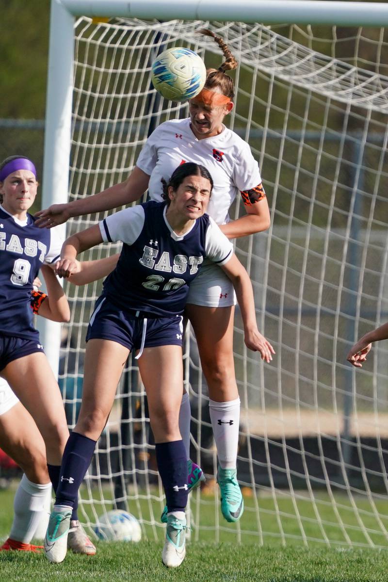 Oswego’s Peyton Johnson (16) goes up for a header over Oswego East's Isabella Rivera (20) during a soccer match at Oswego East High School on Tuesday, April 23, 2024.