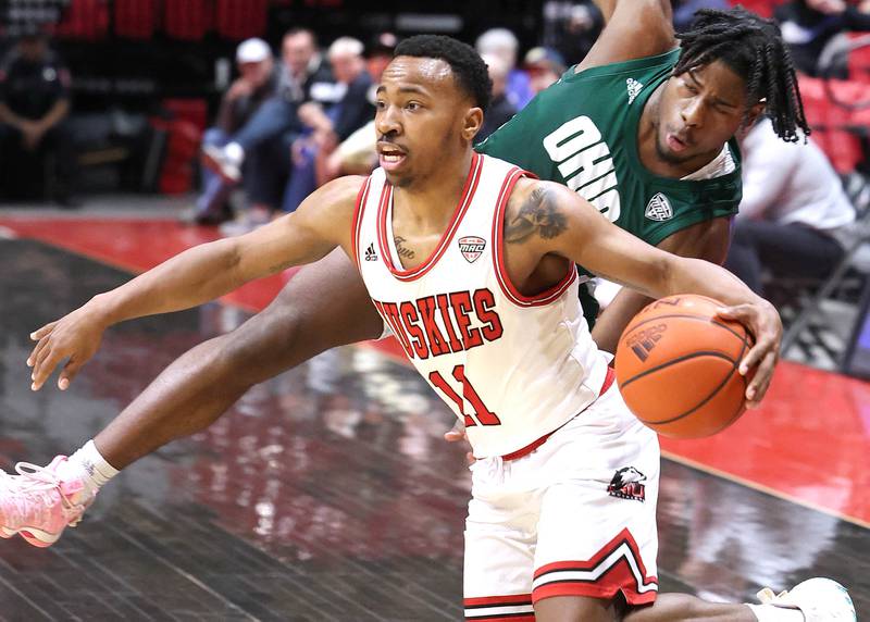 Northern Illinois Huskies guard David Coit gets by Ohio Bobcats guard Elmore James during their game Tuesday, Feb. 7, 2023, in the Convocation Center at NIU in DeKalb.