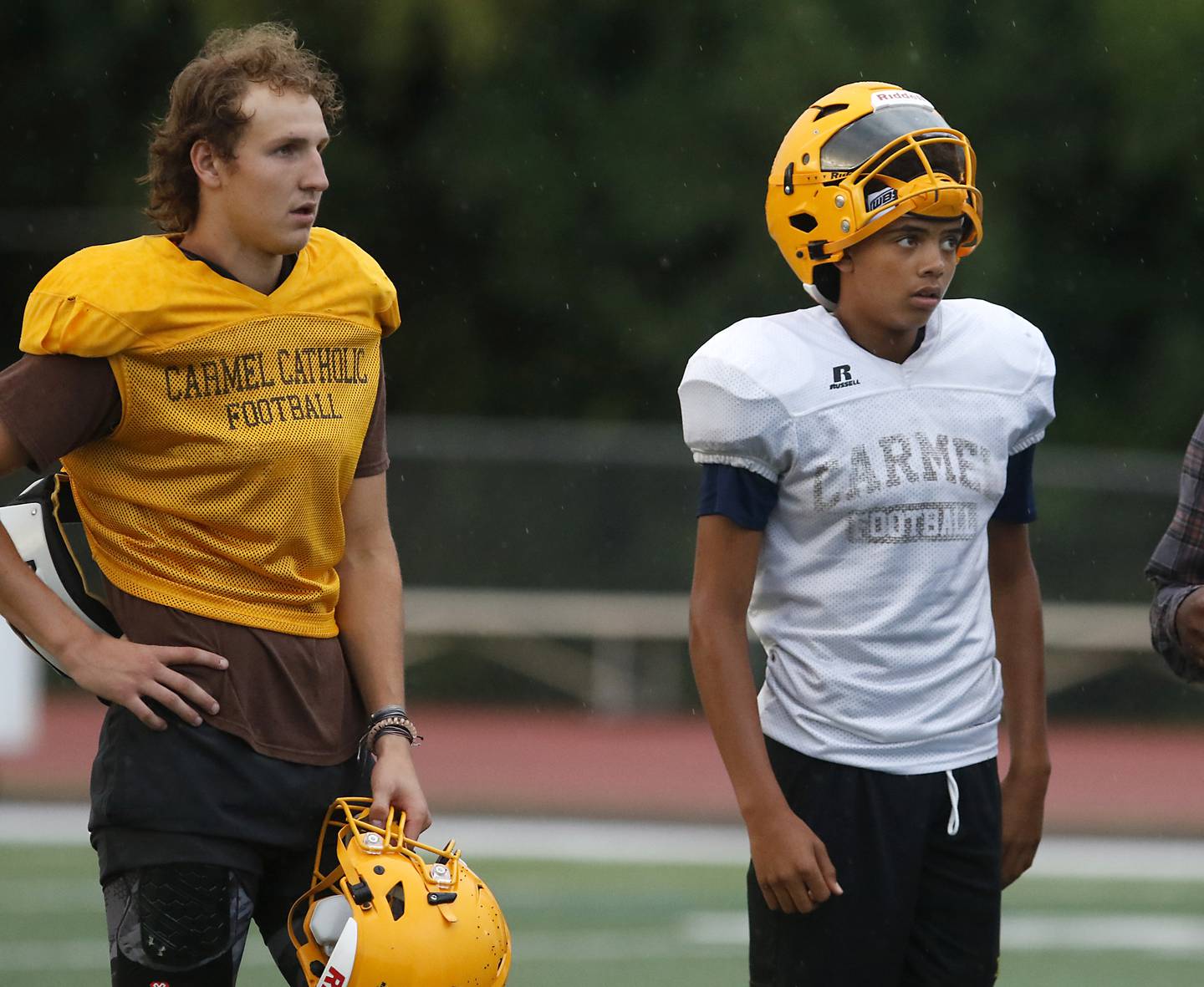 Carmel Catholic quarterback Johnny Weber and freshman quarterback Trae Taylor, a Crystal Lake resident, watch a filed goal attempt Monday Aug. 14, 2023, during practice at the school in Mundelein.