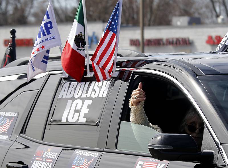 A passenger in a car gives a thumbs up to protesters as they line line State Route 31 near the intersection of McCullom Lake Road in McHenry to protest their discontent with President Donald Trump and his administration's policies on Saturday, March 28, 2026, during the McHenry County No Kings Protest. According to an organizer, over 4,000, people took part in the protest.