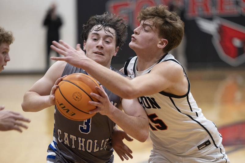 Newman’s Garret Matznick goes to the hoop against Byron’s Ben Hively Friday, Dec. 19, 2025, in the Forreston Holiday Tournament title game.