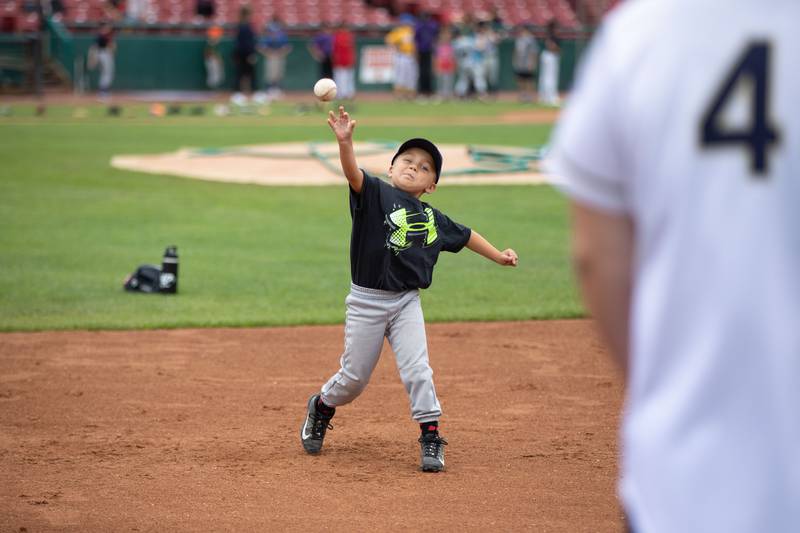 Jackson Holstein (5) of Geneva throws the ball at the fielding station of the Kane County Cougar's Youth Clinic at Northwestern Medicine Field on Saturday, July 16, 2022.