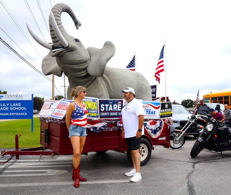 Andro Lerario (right), chairman of the Kane County Republicans, chats with Vice Chairman/SecretaryPamela Carr (left) on Sunday, Aug. 18, 2024 in Lily Lake before participating in a caravan to a rally in Woodstock.