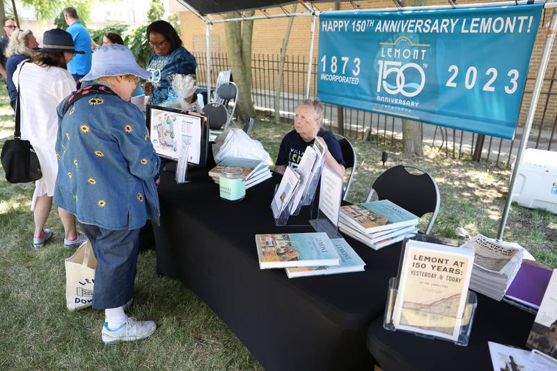 Susan Donahue, President of the Lemont Area Historical Society, right, speaks with long time resident Gail August at the Lemont 150th Anniversary Commemoration on Friday, June 9, 2023 in downtown Lemont.