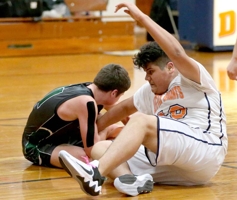 Midland's Quin Gauwitz (left) and Depue's Ramon Arevalo (right) fight over a jump ball on Monday, Dec. 19, 2022 at DePue High School.