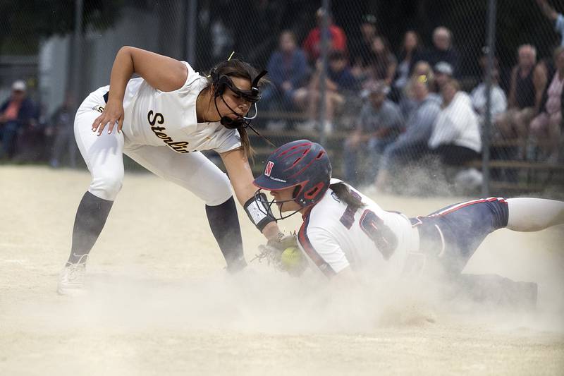 Sterling’s Layla Wright tags out Belvidere North’s Alexa Norgard Friday, May 30, 2025, in the Class 3A Regional final in Dixon.
