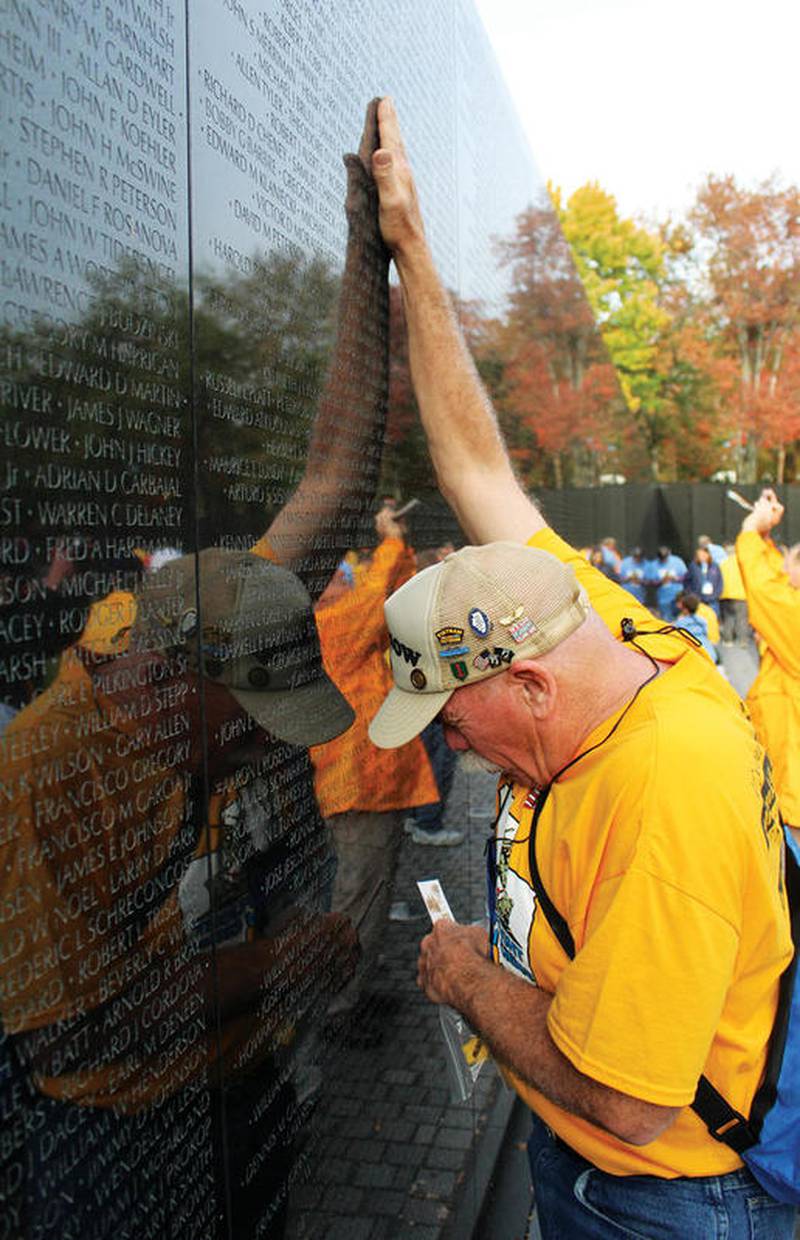 John Tuttle remembers his fallen brother, Sergeant George Coody, while visiting the Vietnam memorial wall during the 42nd Lee County Honor Flight in 2017.