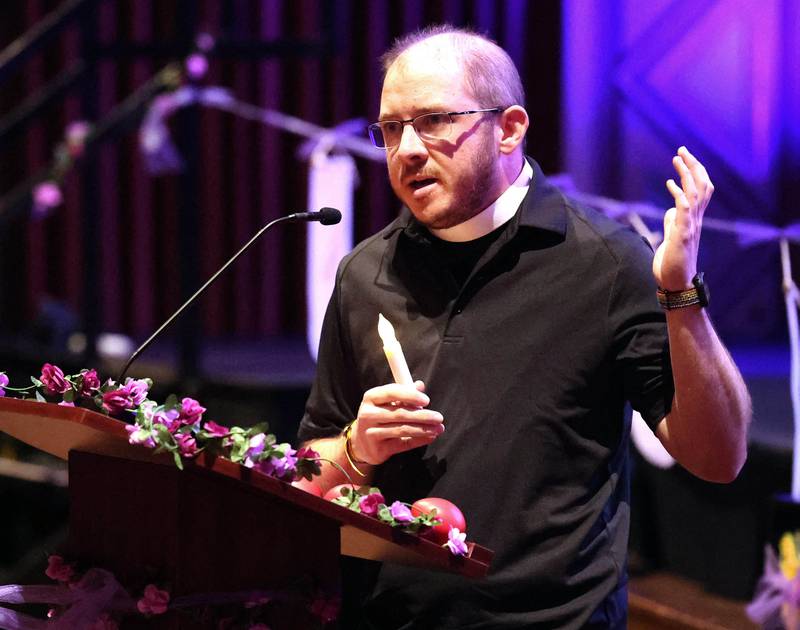 Pastor Mack Patrick speaks as people turn on their candles during the Safe Passage Candlelight Vigil and Survivor Speak Out Monday, Oct. 6, 2025, at the Egyptian Theatre in DeKalb.