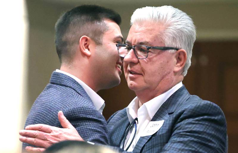 John Pappas hugs his son Foti after John was inducted into the Business Leaders Hall of Fame Thursday, Feb. 9, 2023, during the DeKalb Chamber of Commerce’s Annual Celebration Dinner in the Barsema Alumni and Visitors Center at Northern Illinois University.