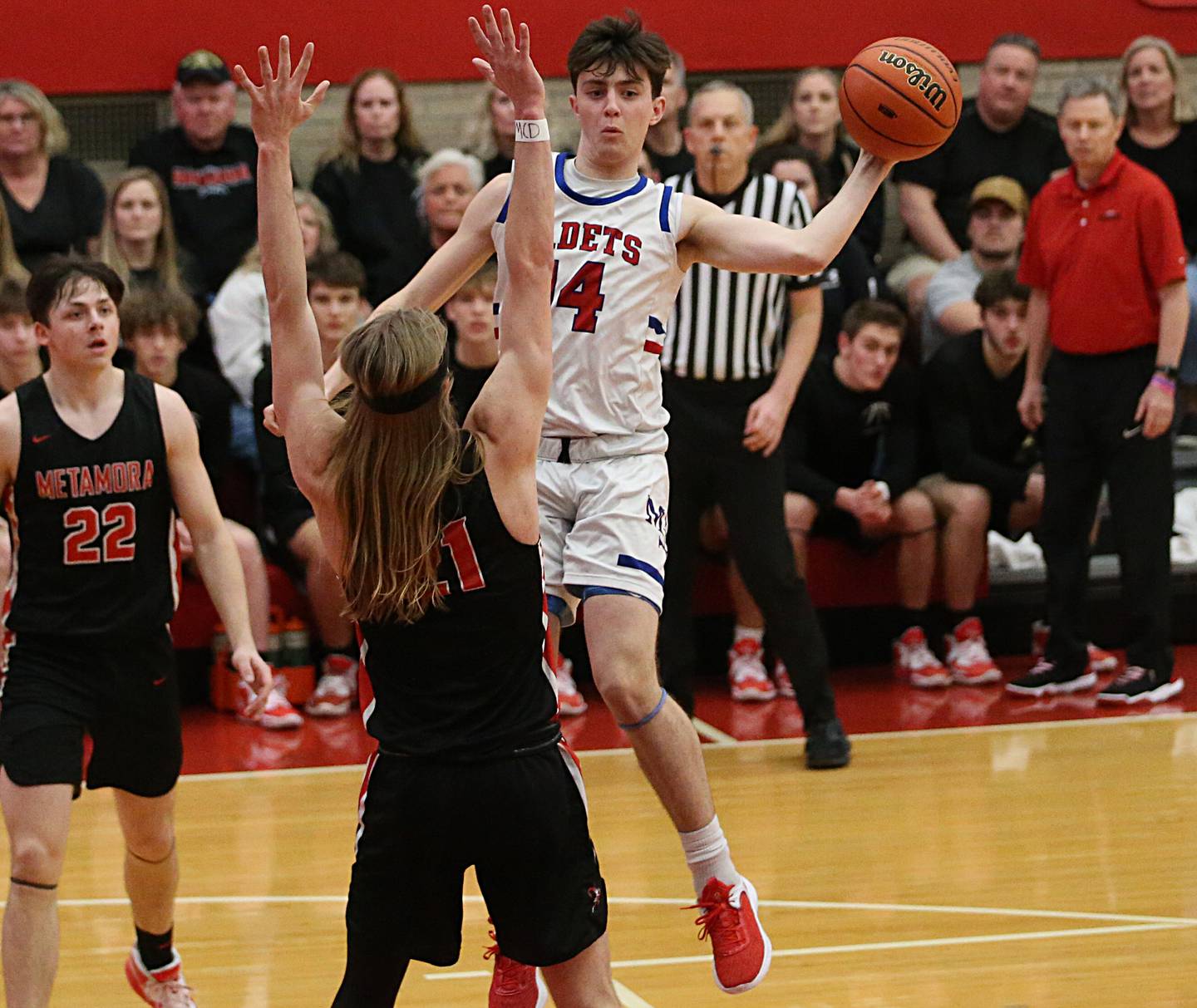 Marmion's Evan Stumm passes the ball around Metamora's Ethan Kizer and Tyson Swanson during the Class 3A Super-Sectional on Monday, March 6, 2023 at Ottawa High School.