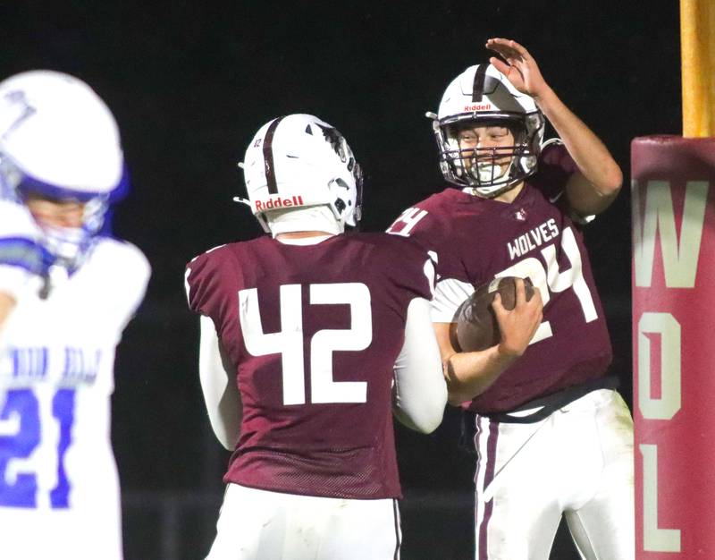Prairie Ridge’s Vincent Byk, right, is greeted by Hunter Mosolino after a Byk touchdown against Vernon Hills in IHSA football Class 5A first-round playoff action at Prairie Ridge High School in Crystal Lake on Friday, October 31, 2025.