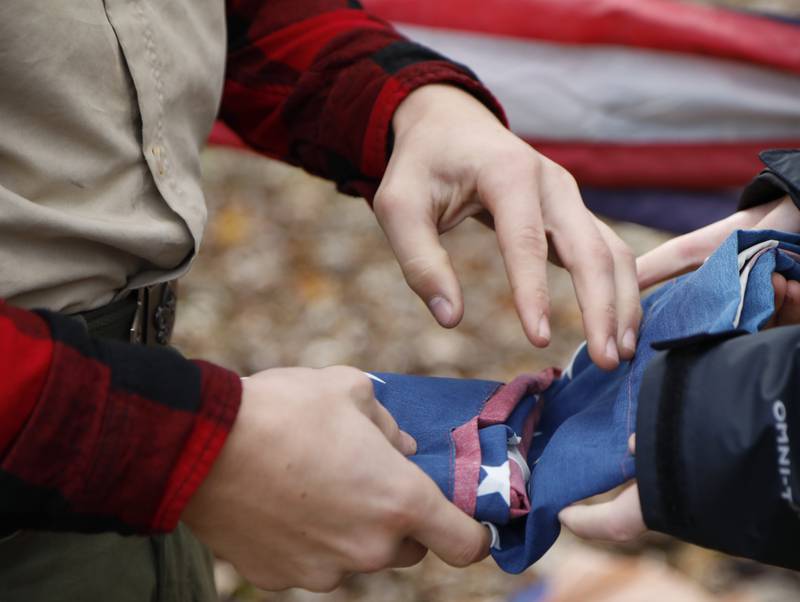 Boy Scouts fold an American flag that is about to be retired during the Annual Veterans Day Scout VFW vigil and flag retirement ceremony at Overseas VFW Post 1197 in Batavia on Saturday, Nov. 5, 2022.