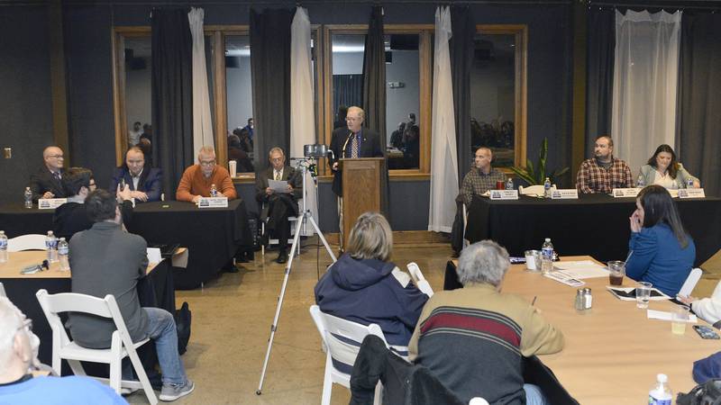 Streator mayoral candidates Brian Crouch (far left) and Tara Bedei (far right) listen as City Council candidate David Reed speaks to those in attendance Thursday, March 9, 2023, at the Eastwood in Streator.