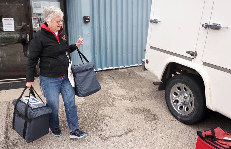 Colette Theurer, a driver with the Voluntary Action Center, loads up a truck with meals for delivery Thursday, Nov. 17, 2022, at the facility in Sycamore. VAC delivers meals to the homebound and elderly along with providing transportation options.