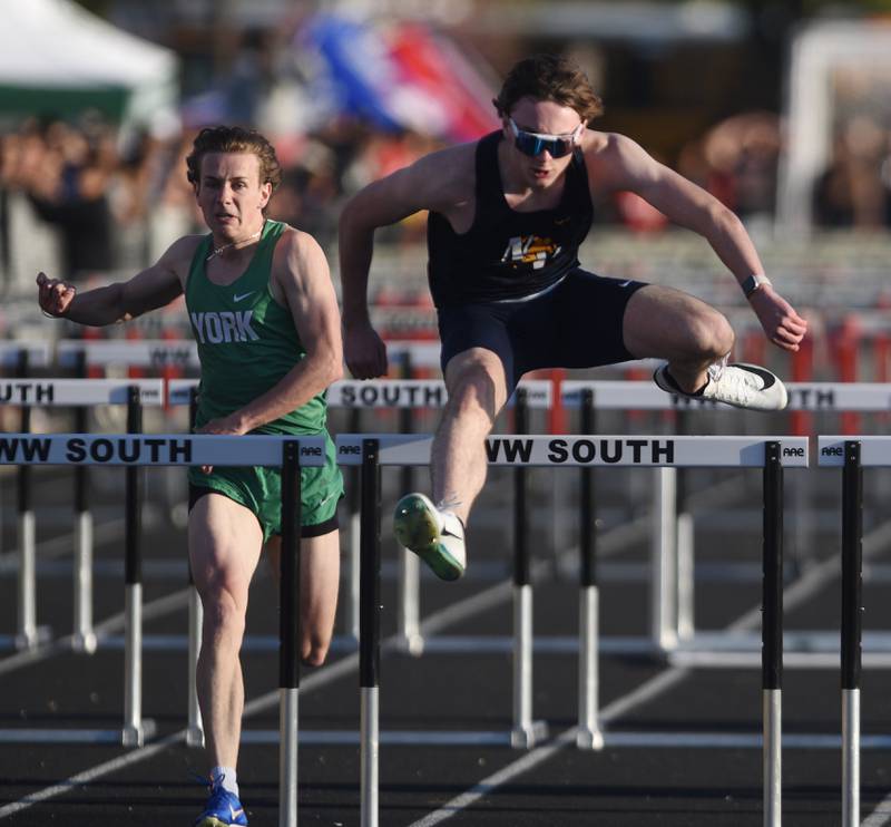 Neuqua Valley's Cooper McGinnis clears the final hurdle as he wins the 100-meter high hurdles during the DuPage County boys track and field meet at Wheaton Warrenville South High School on Friday, May 9, 2025 in Wheaton. The York Competitor is Luke De Simone.