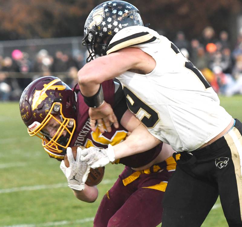 Stockton's Carter Blair is tackled by Lena-Winslow's Miles Mahon in 1A semifinal action in Stockton on Saturday, Nov. 22, 2025.