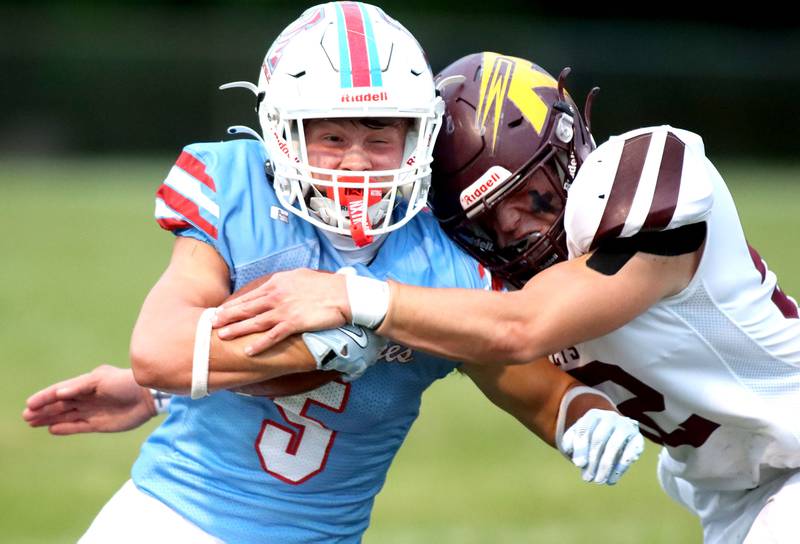 Marian Central’s Mike Schmid, left, is hit by Richmond-Burton’s Bryce Kowal in varsity football at George Harding Field on the campus of Marian Central High School in Woodstock on Friday, August 29, 2025.