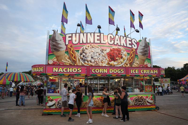 A group gather to get funnel cakes at Old Canal Days on Friday June 7, 2024 in Lockport.