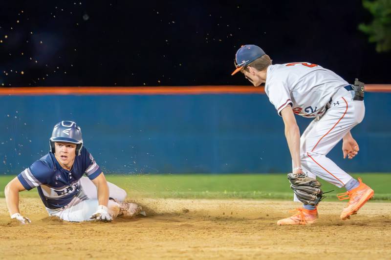 Oswego East's Liam Mitchell (6) steals second base against Oswego during a baseball game at Oswego East High School on Tuesday, May 9, 2023.