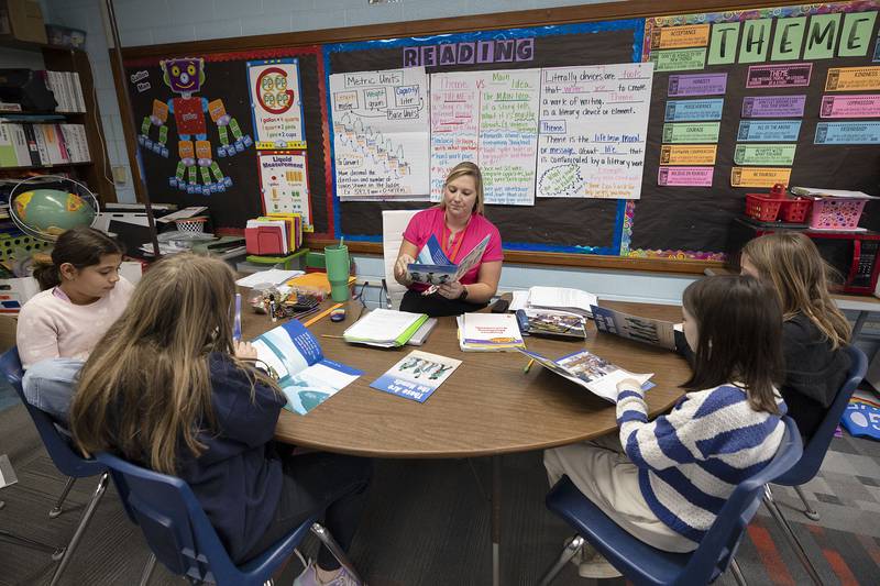 Fifth grade teacher Bree Naftzger works on reading with her students Thursday, Nov. 13, 2025, at East Coloma-Nelson.
