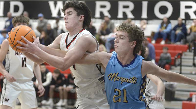 Marquette’s Bradyn Hermann tries to knock the ball away from Woodland’s Brezdyn Simons in the 1st period Friday at Woodland.