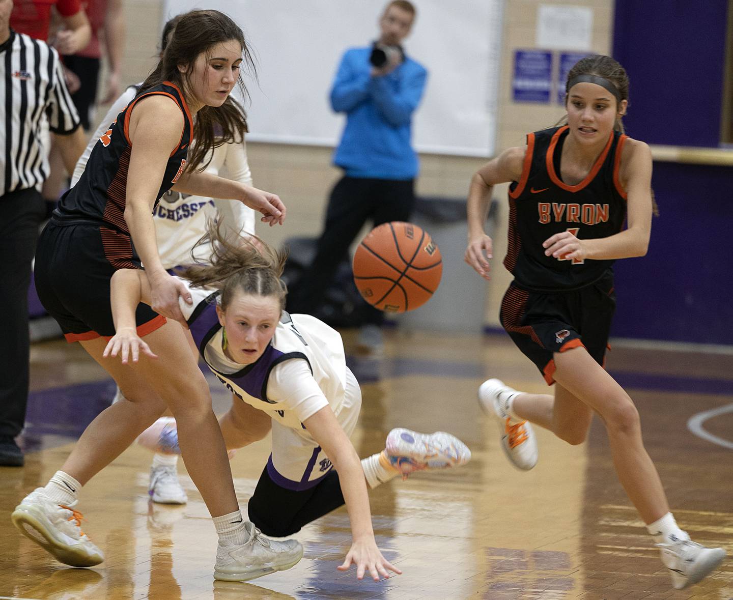 Dixon’s Katie Drew is tripped up late in the game against Byron Tuesday, Jan. 24, 2023.
