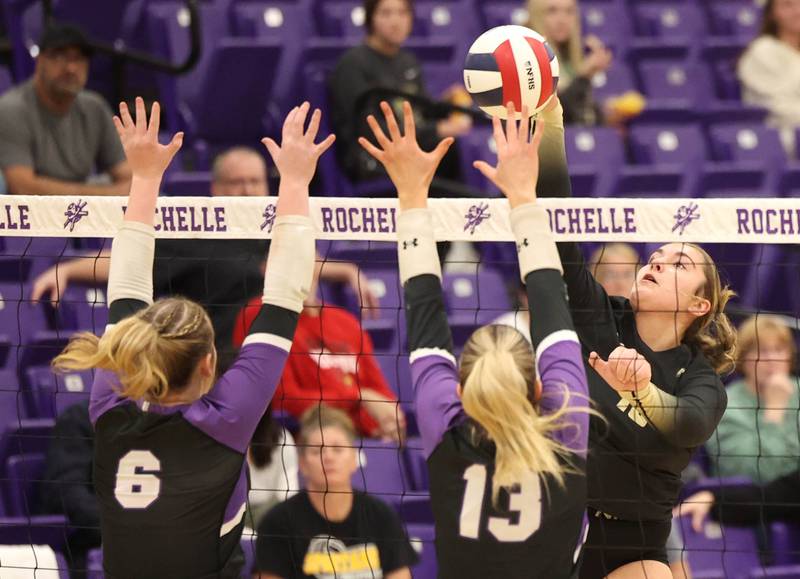 Sycamore's Isabella Culotta tries to spike the ball by Dixon's Rayven Mowery (right) and Solis Thompson Thursday, Oct. 30, 2025, during their Class 3A regional championship match in Rochelle.